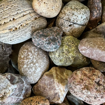 A pile of miscellaneous rocks with different colors and patterns