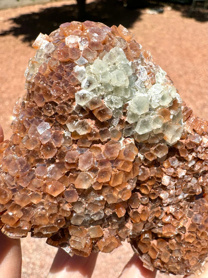 Detail of a rounded point of the piece, with a patch of white crystals. The pseudo-hexagonal growth on this side is flattened like a diamond shape.