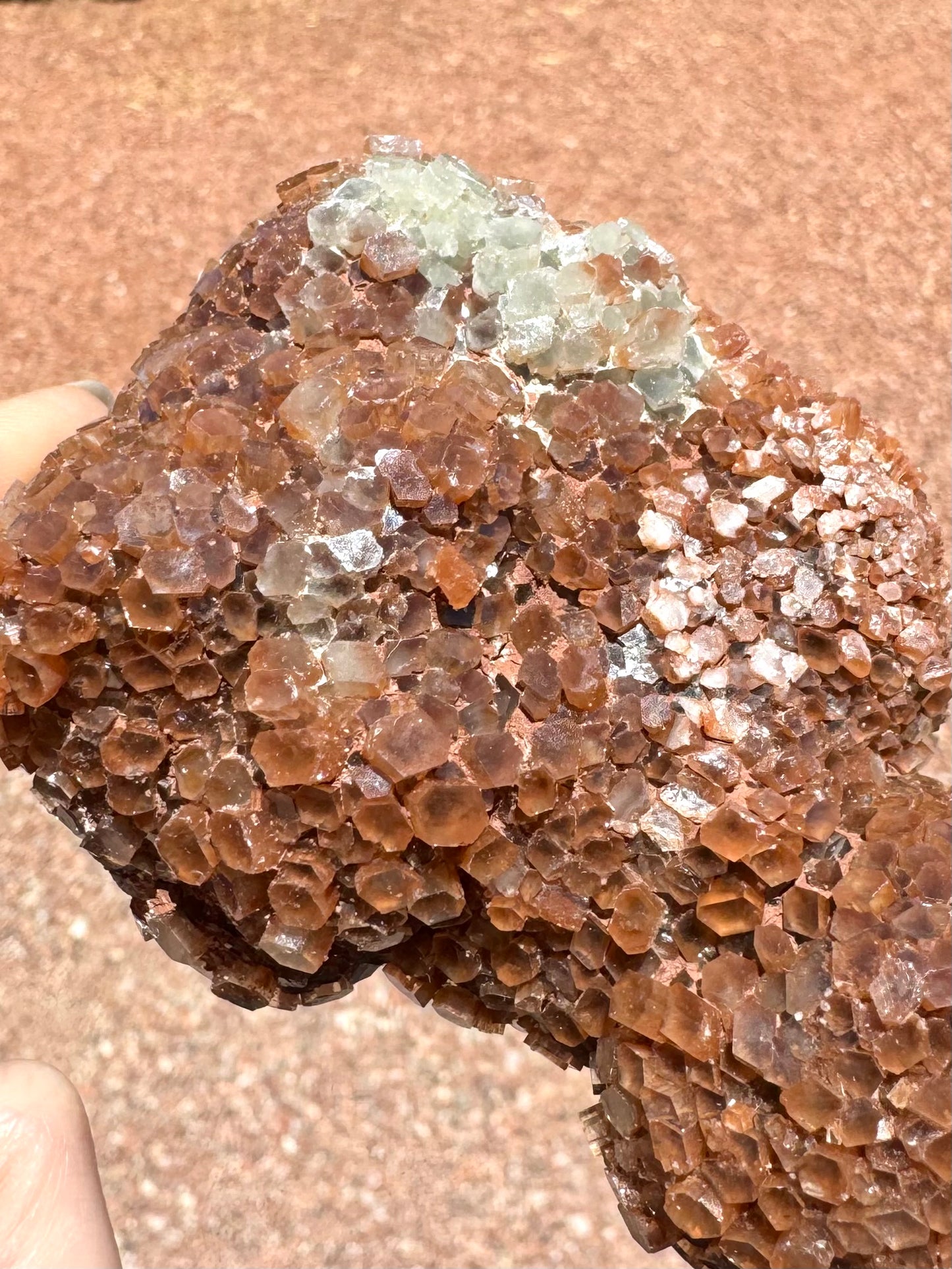 Detail of another side with red-brown crystals and some milky lighter ones. The white crystals are near the back.