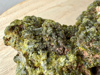 Detail of a well-formed quartz prism embedded in thick stacked, fanning epidote growth.