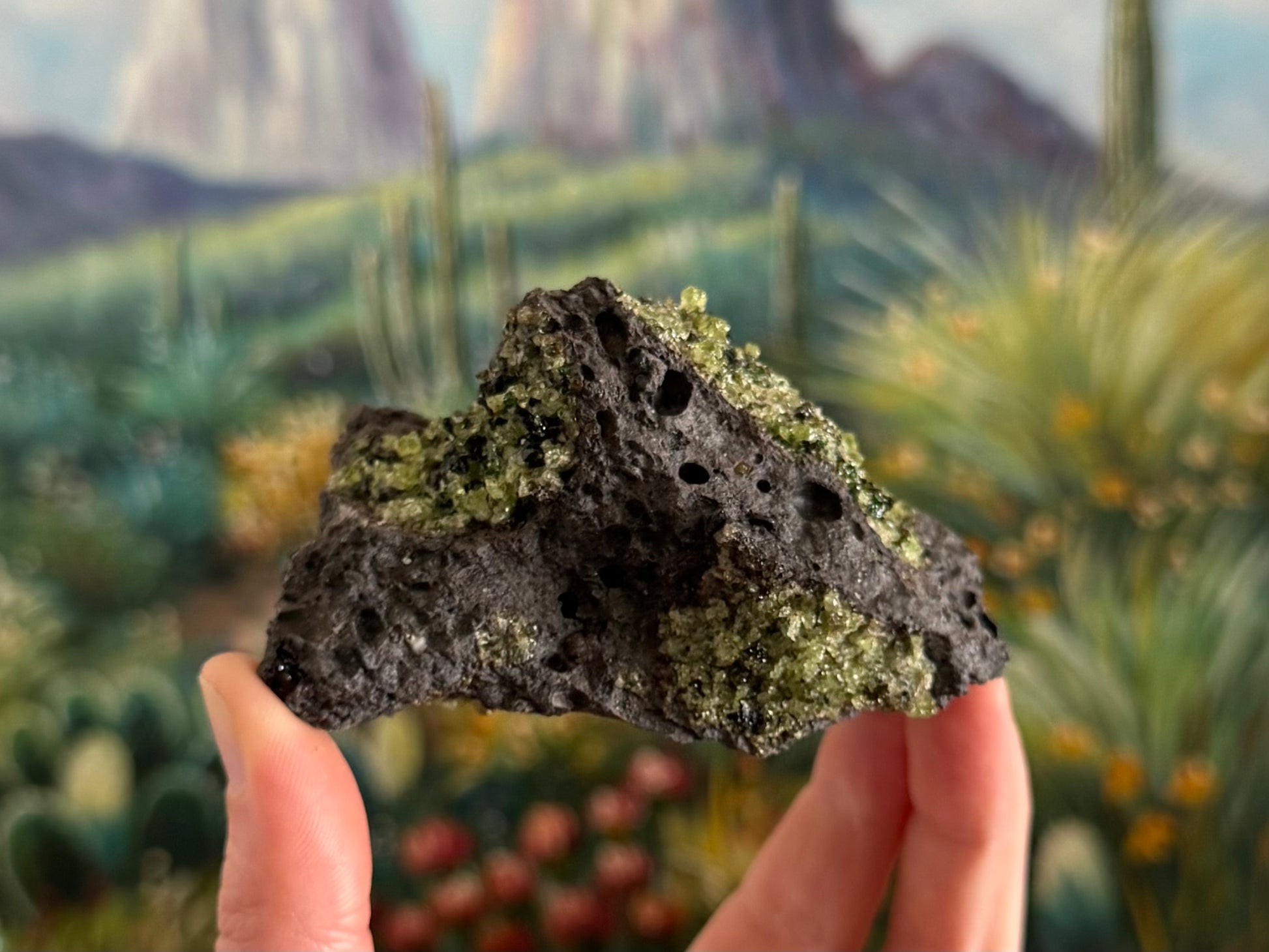 A triangular side of the piece with three patches of peridotite visible.