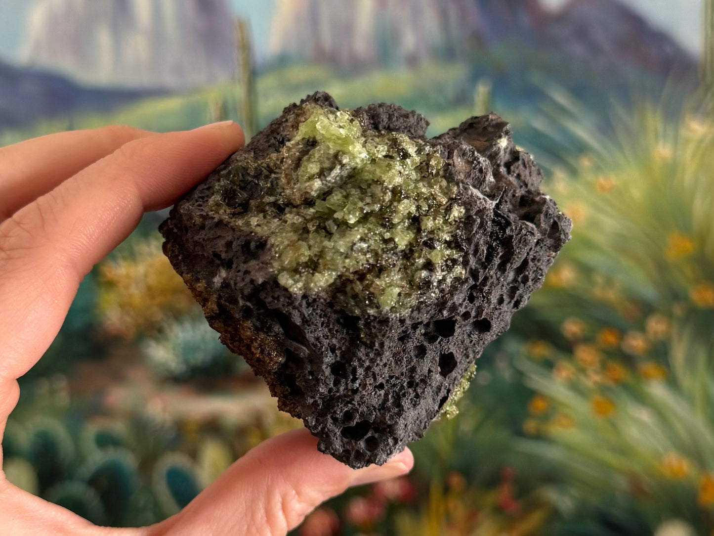 A view of a triangular side of the piece with a patch of peridotite at the top an layer of a dark mineral on the left side.