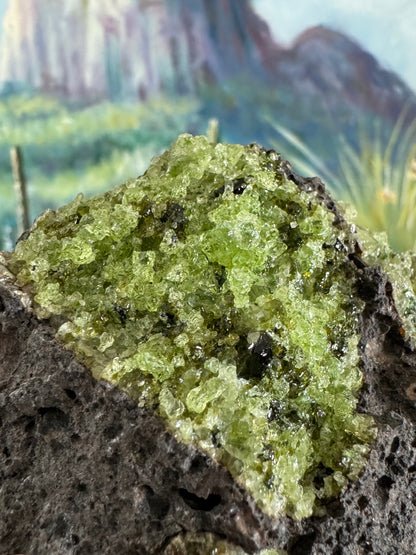 Close detail of the composition of the bumpy irregular green minerals. There are large light yellow-green crystals of olivine, with some dark forest green pieces of spinel sprinkled through.