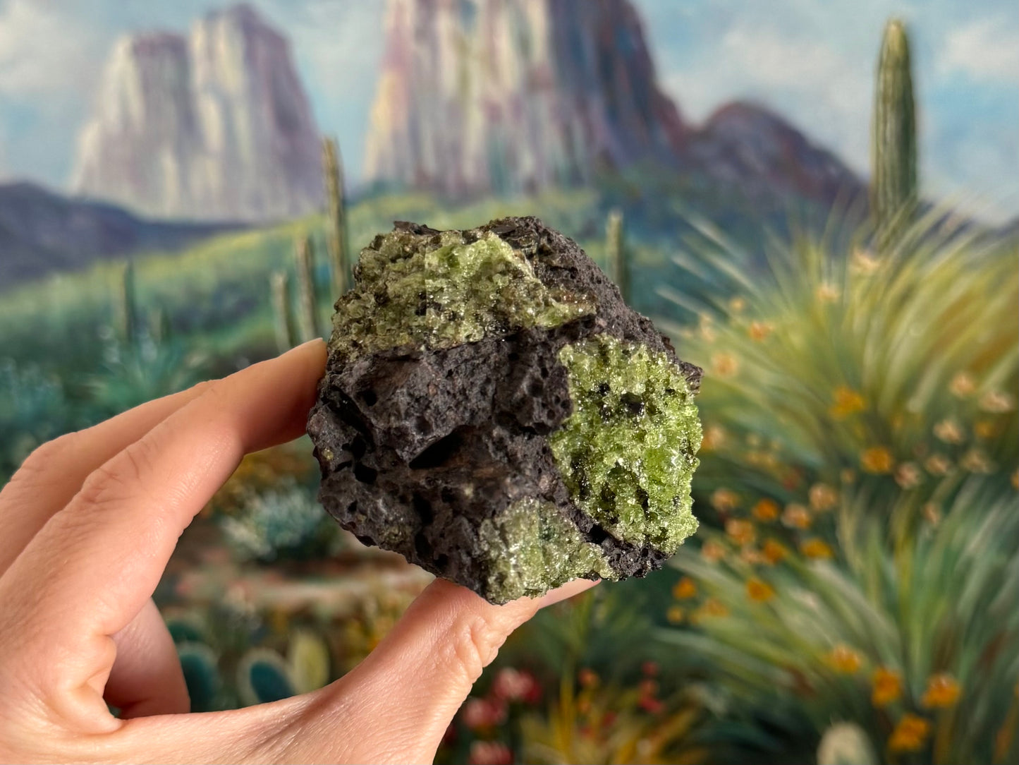 A view of the piece with three patches of peridotite visible. The one on the right side has saturated green color and gemmy translucency.