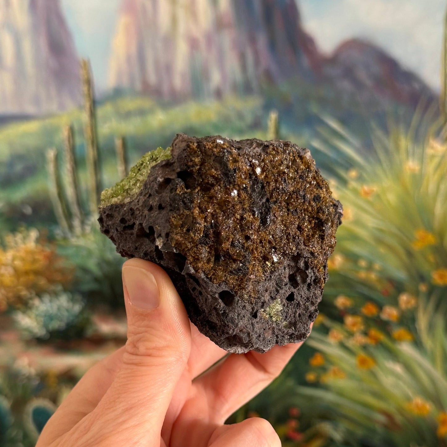 A side of the specimen largely coated with an orange-brown mineral with irregular form and shiny semi-translucent crystals.