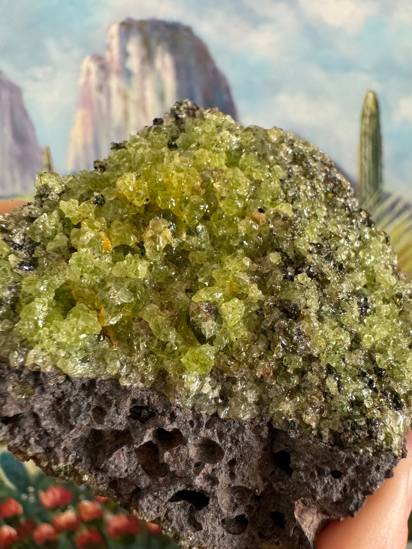 Detail of the large gemmy irregular olivine crystals in the front, with some small dark spinel and diopside crystals mixed in.