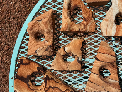 Sandstone arches spread over a tabletop, with similarly colored gravel under them