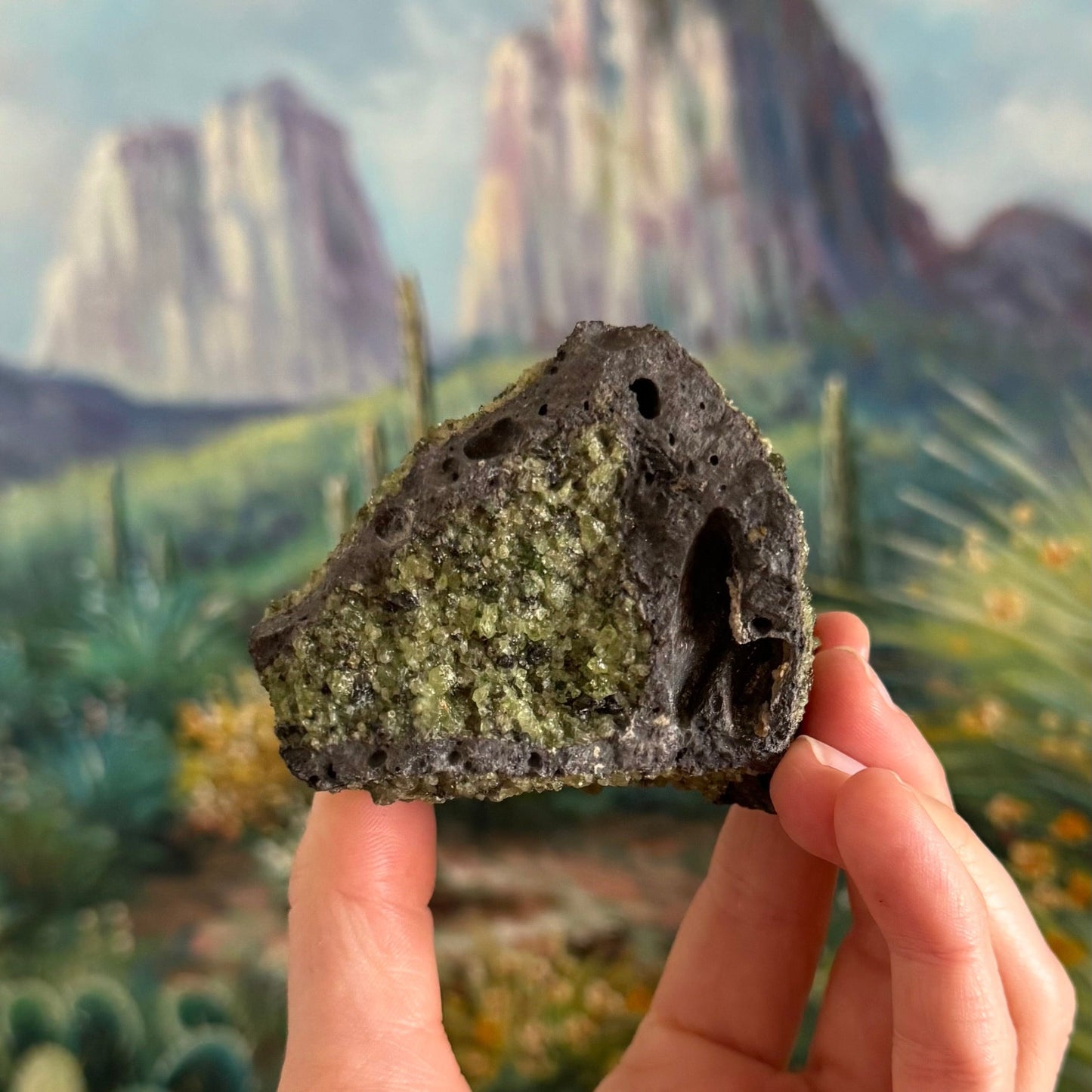 A triangular side of the chunk, with a rim of volcanic rock and the center of the face covered in a pocket of peridotite. There is a large long bubble hole on the right side.