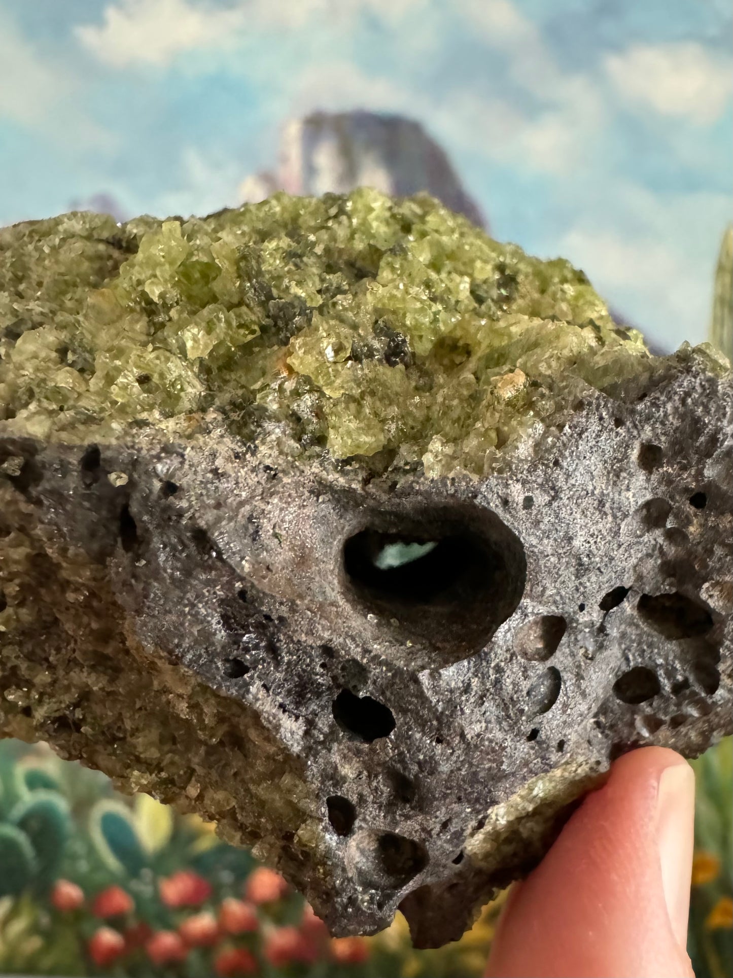 Detail of a long thin bubble hole through the piece, with a thick layer of peridotite over the top.