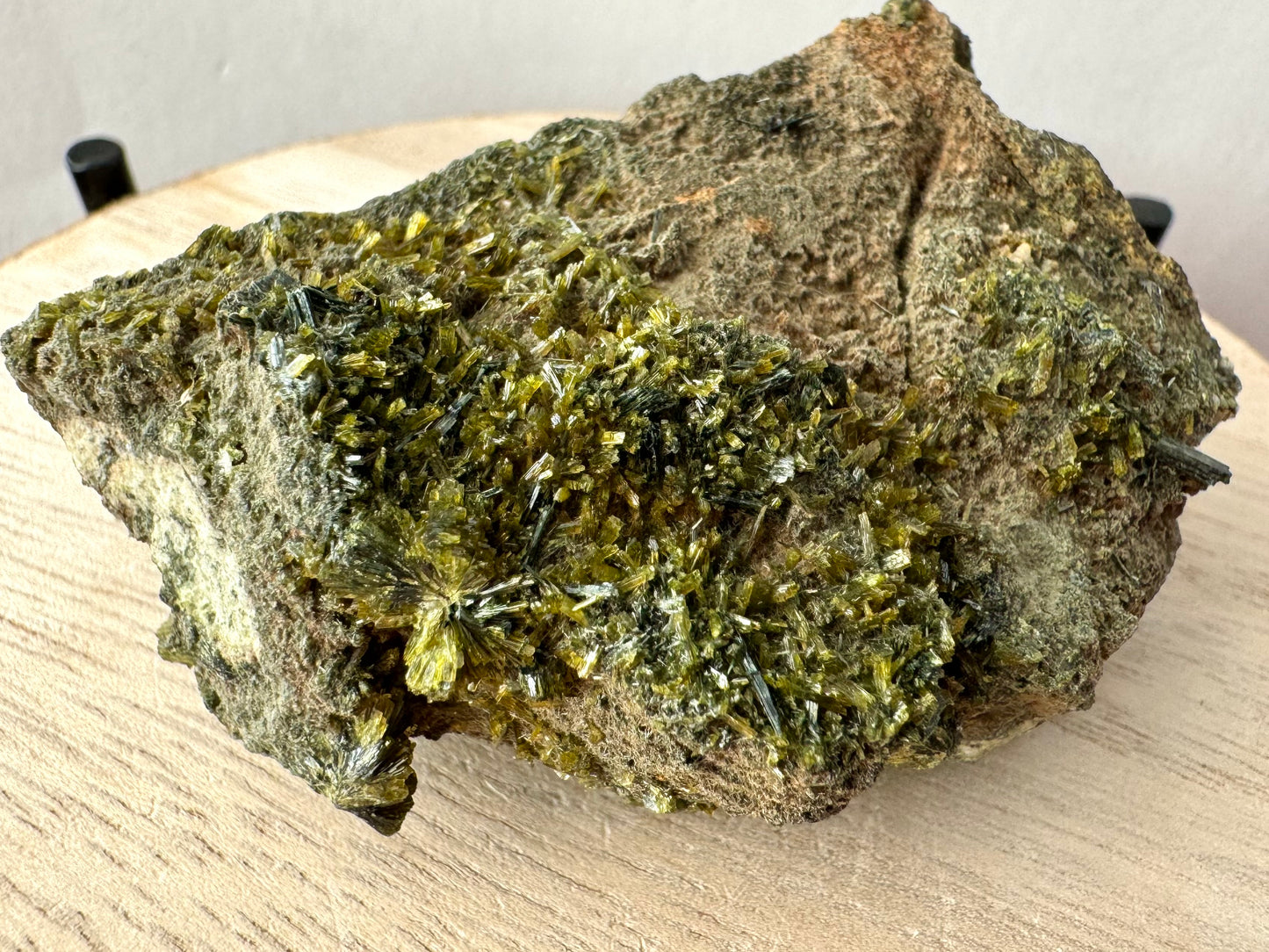 Detail of lighter green epidote sprays and crystals on one side of the piece