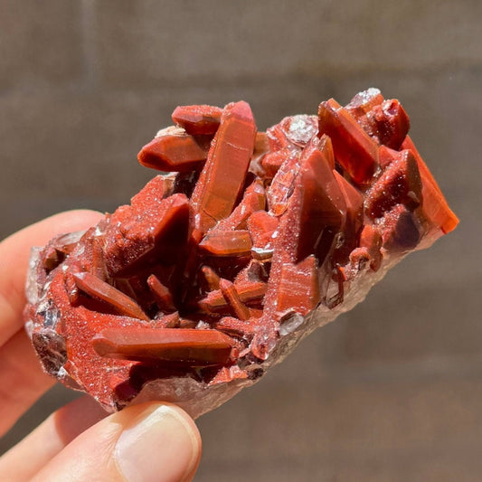 A rectangular piece of matrix covered with well-formed red quartz points, with smooth saturated red color and one side of crystals coated with a glittering druzy.