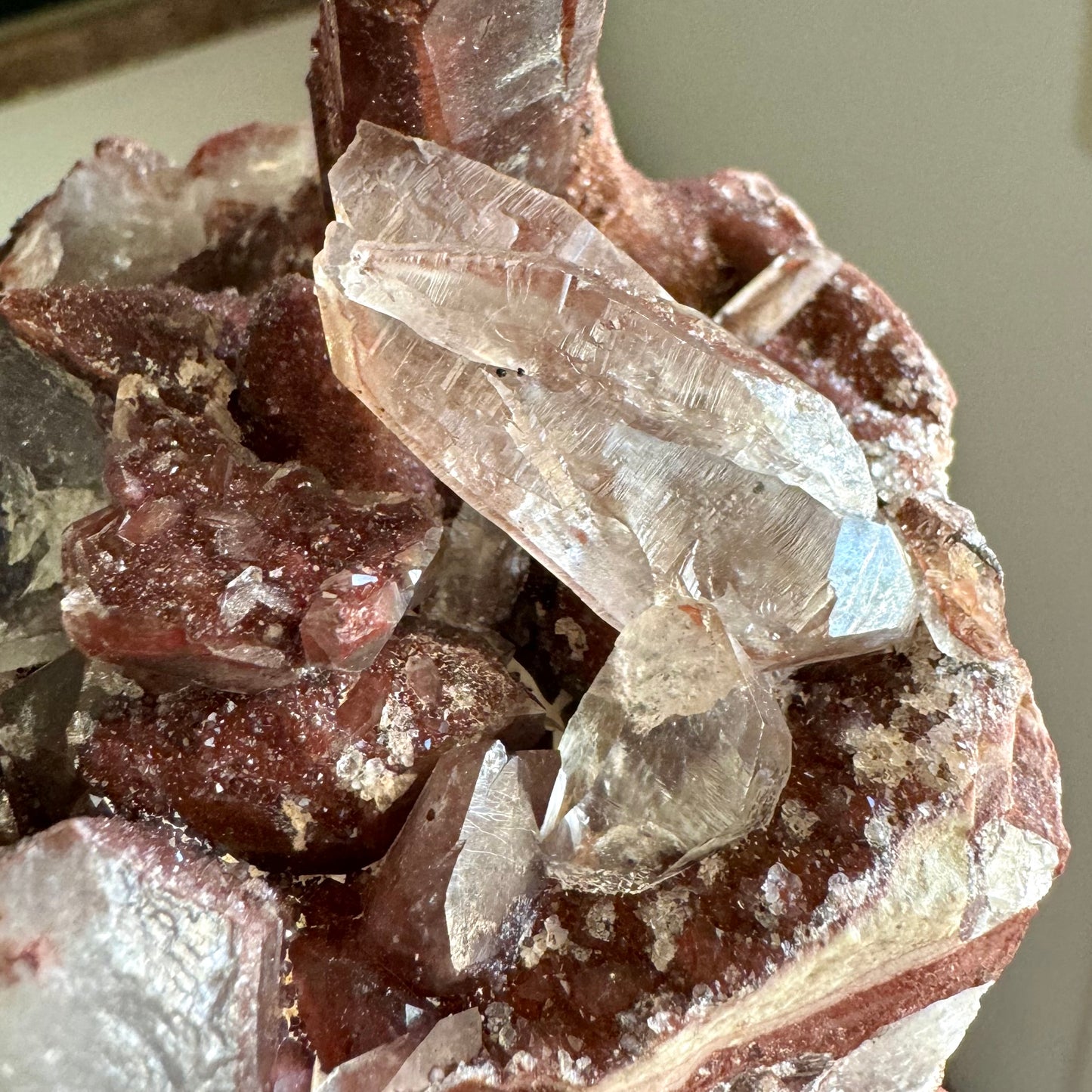 Detail of the colorless quartz crystals perched atop the specimen, oriented point-down. The quartz pieces have good horizontal striations.