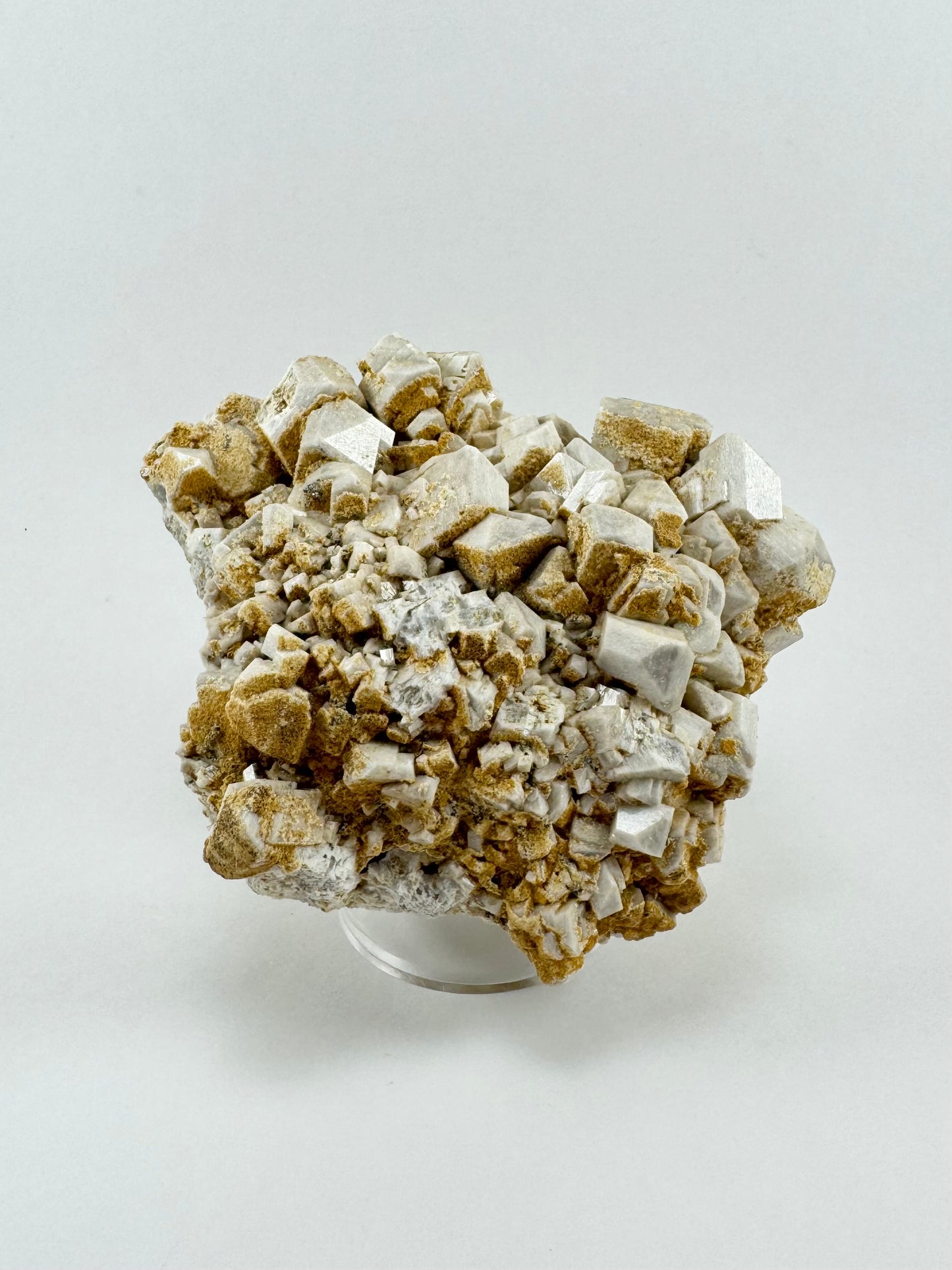 Full view of the piece showing good composition of large and small microcline crystals partially coated with sandy-looking siderite.