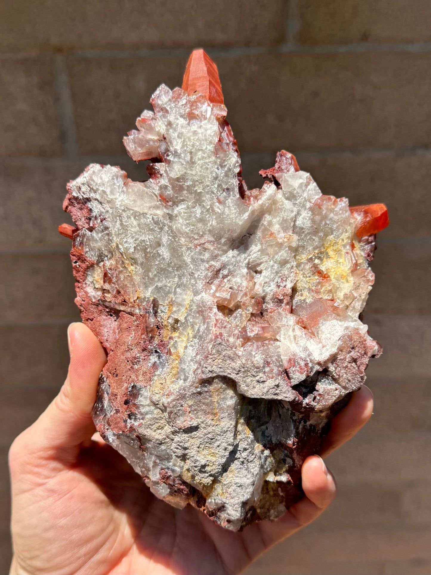 The underside of the specimen, a rough mass of whitish quartz, with patches of yellow.