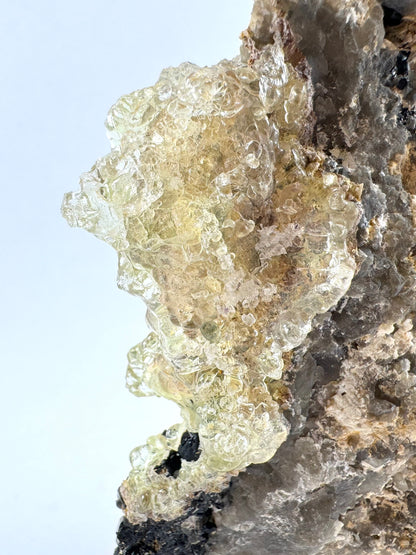 Detail of the hyalite on the top of the specimen, a light yellow tinted transparent growth.