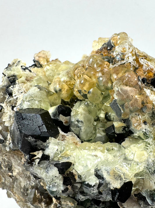 Black tourmaline in albite matrix with hyalite and minor fluorite