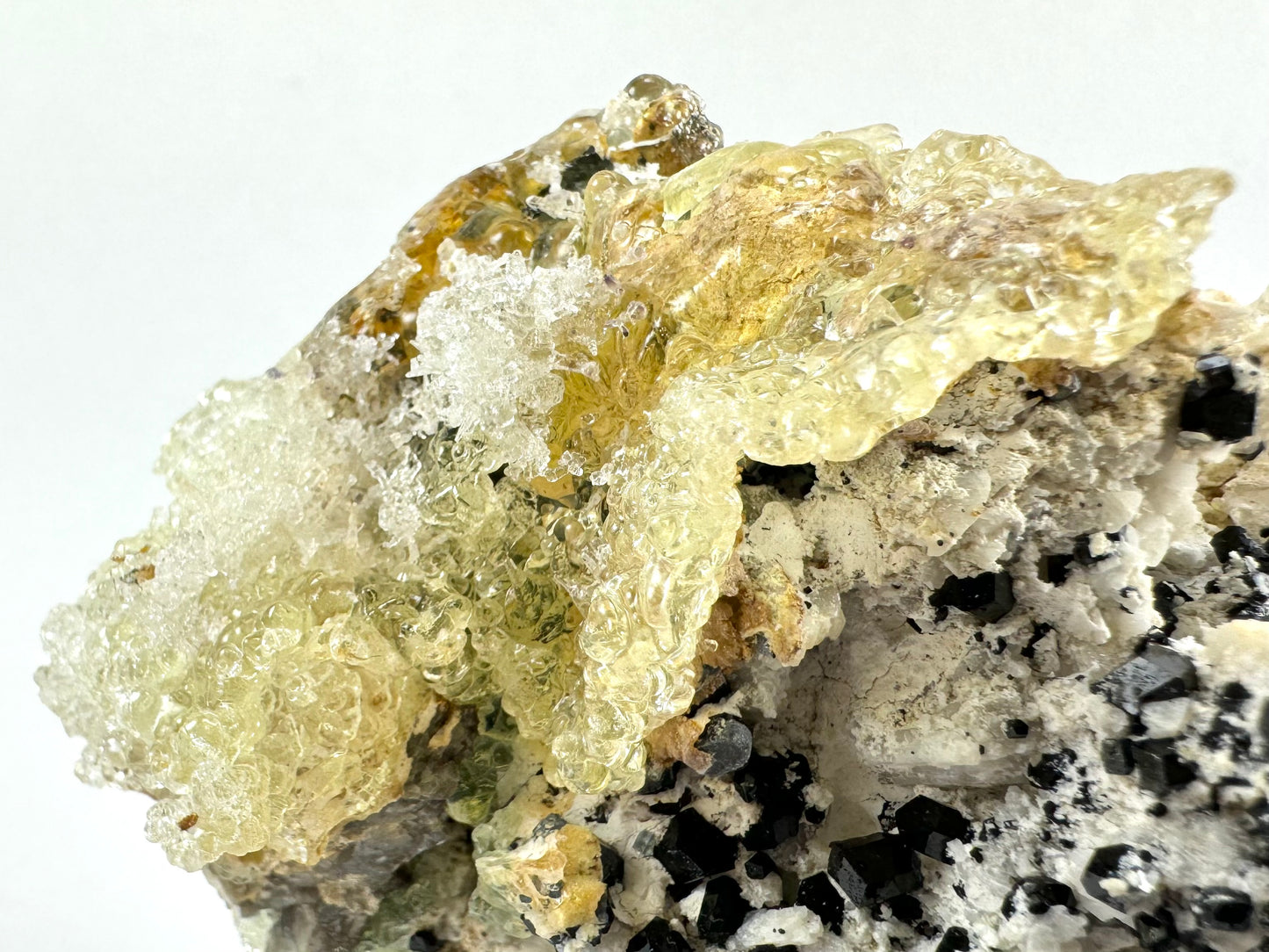 Black tourmaline in albite matrix with hyalite and minor fluorite