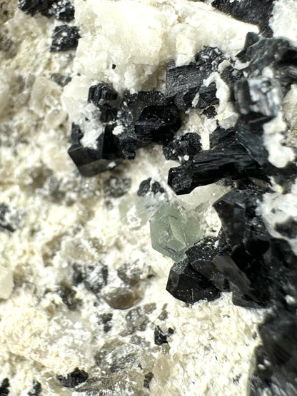 Black tourmaline in albite matrix with hyalite and minor fluorite
