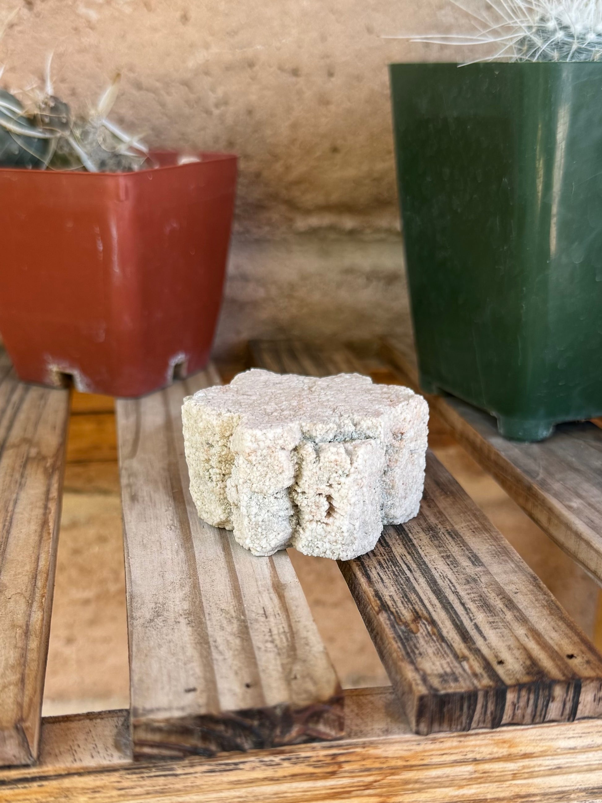 The piece on its side, showing an inverted crevice on one side, with mineral texture almost like shredded wheat on either side