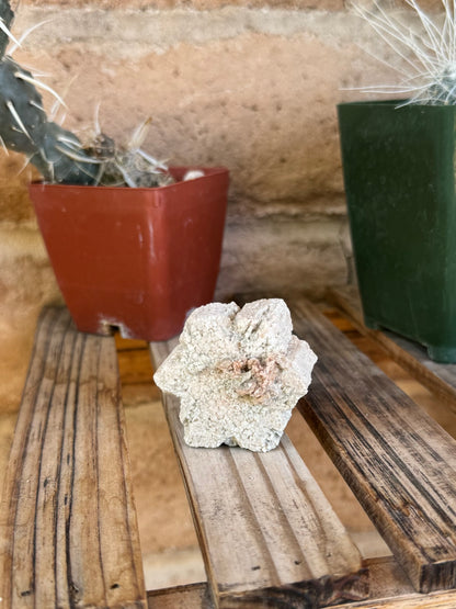 The piece stood on-edge, showing the face with a cluster of minerals. It doesn't have the the most perfect snowflake silhouette, edges aren't straight and symmetrical.