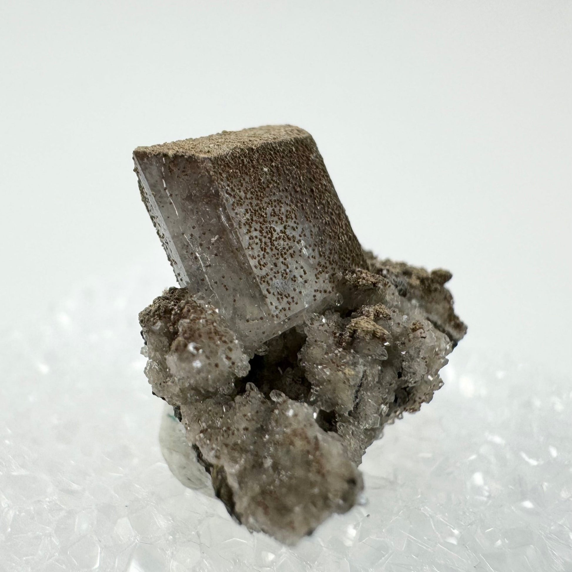 Detail of the gradient of small brown lizardite crystals covering the hydroxyapophyllite, densest on the far corner and fading to fewer at the near corner