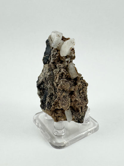 Angled view of the specimen showing the dark matrix, and a cluster of crystals at the top of the specimen