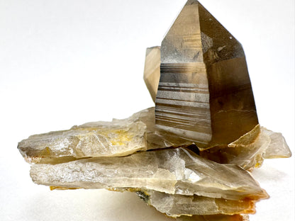 View of one end of the specimen, with layers of thin broken shards of smoky quartz forming the base under the two points.