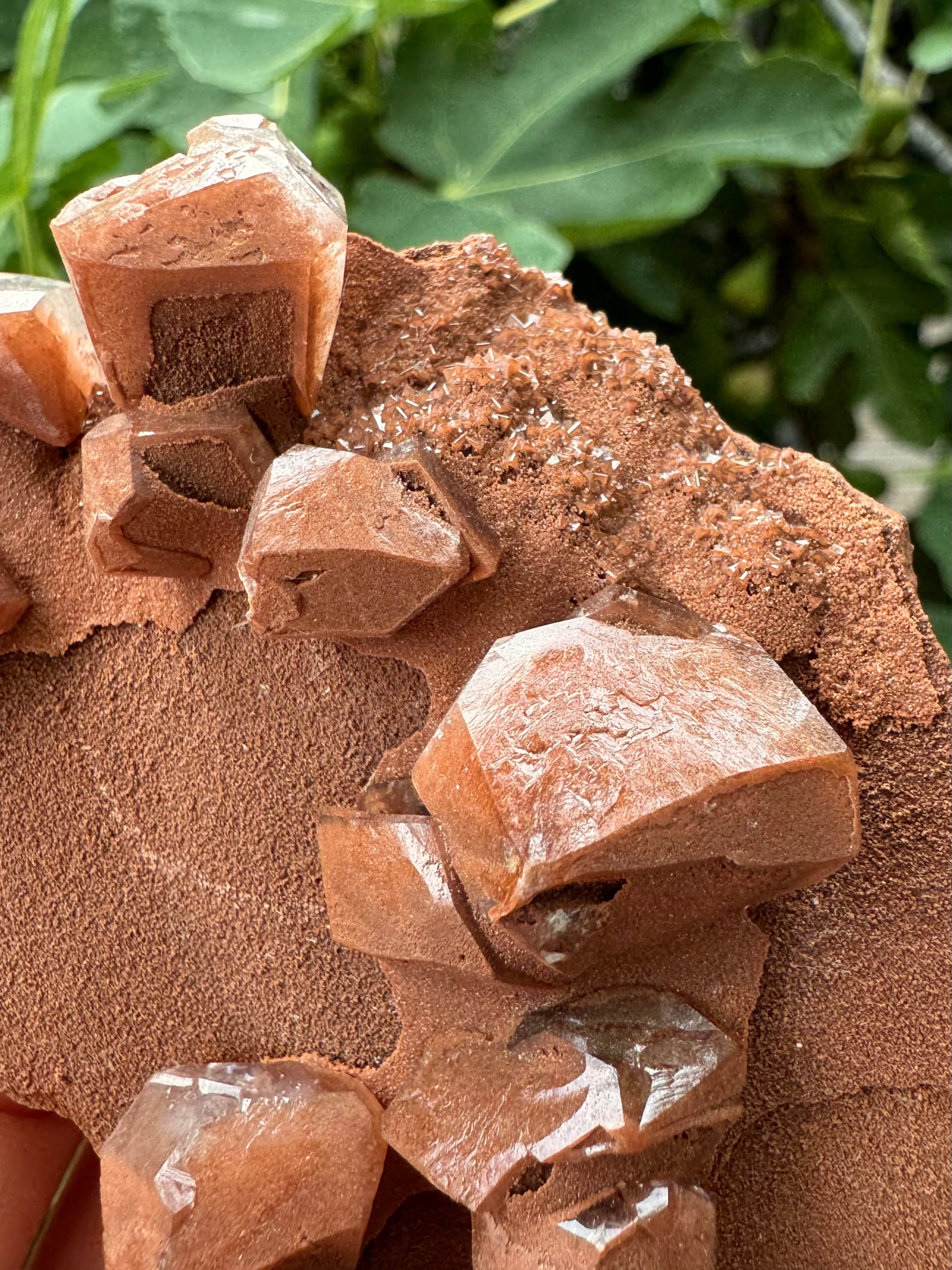 Detail of the blocky angular brown calcite crystals, with some pointy calcite druzy coated in the sandy brown mineral.