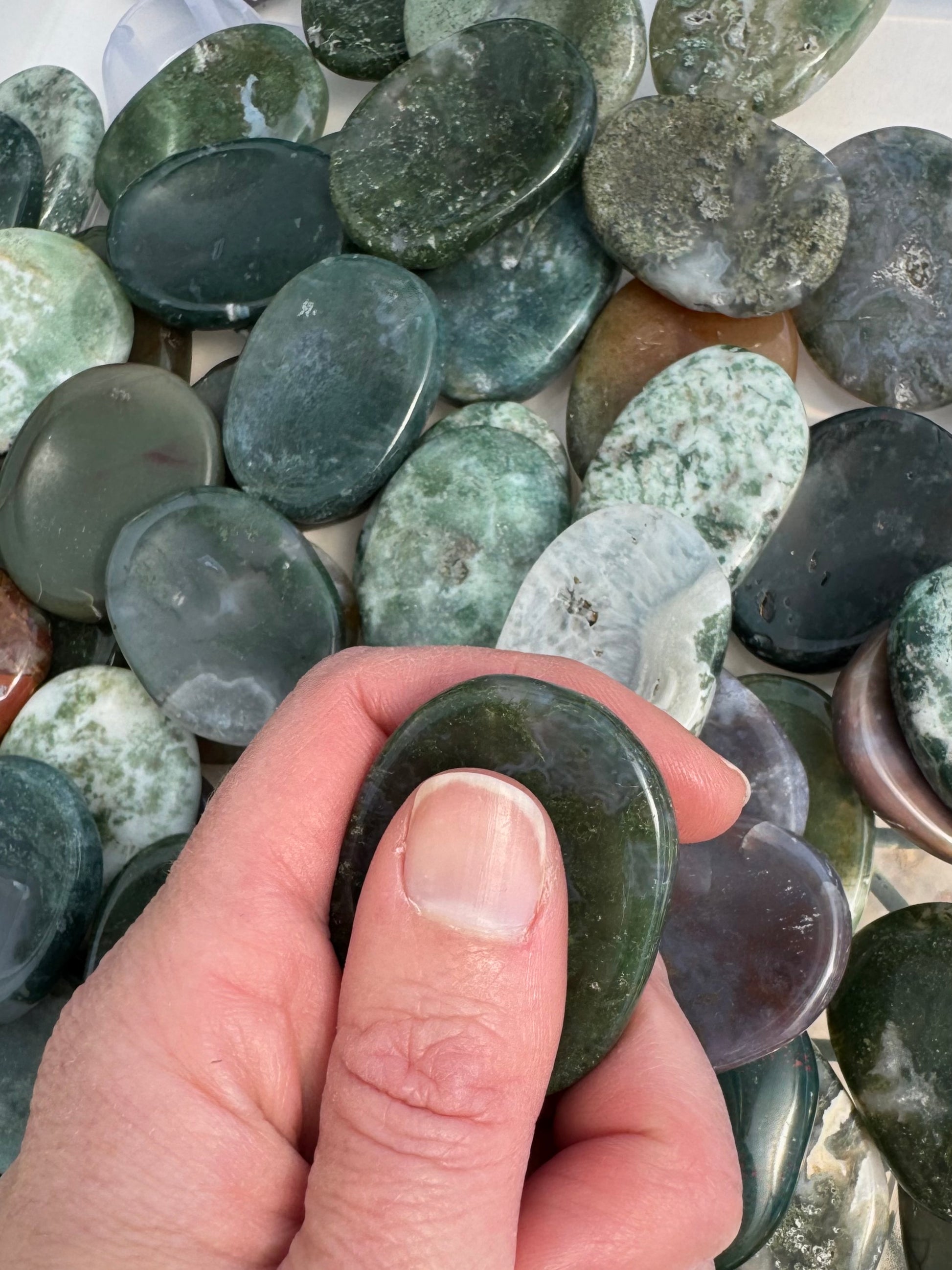 Worry stone in use, held with thumb and fingers