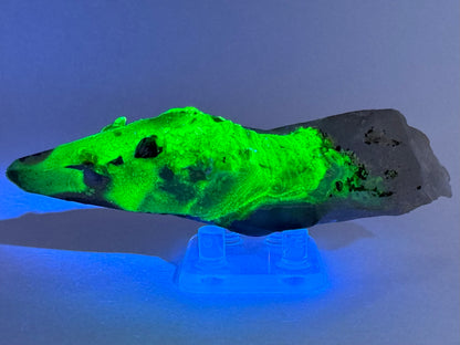 The third of three lighting images: the point in low light in the same position as the previous image, illuminated in blue-tinted UV light. The hyalite fluoresces strong yellowish-green.