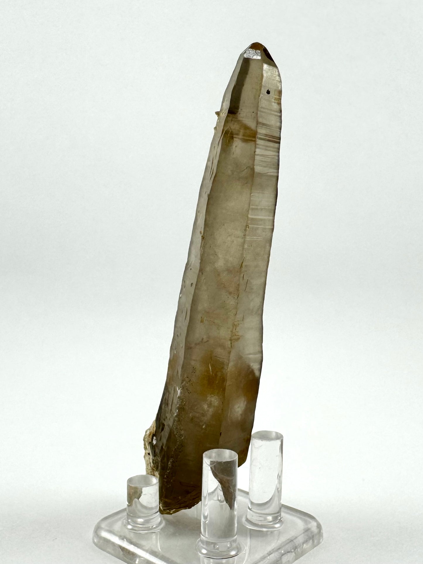 View of another side of the piece, again emphasizing well-formed horizontal striations on quartz faces, and back-lighting the wispy inclusions