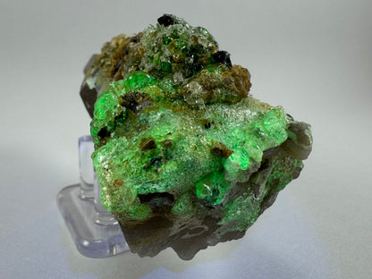 Third of three lighting images: the base of the mineral in dim light illuminated in UV light. The hyalite fluoresces a strong yellowish-green.