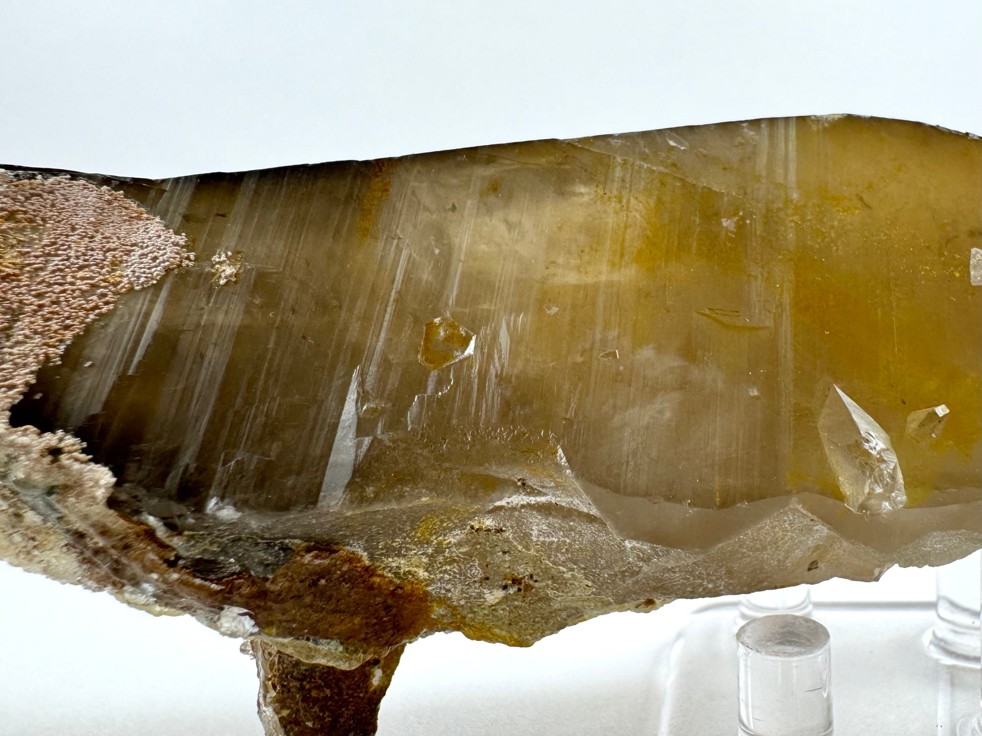 Another view of the middle of the piece, with the inclusions lit differently and light on the surface striations of the quartz face.