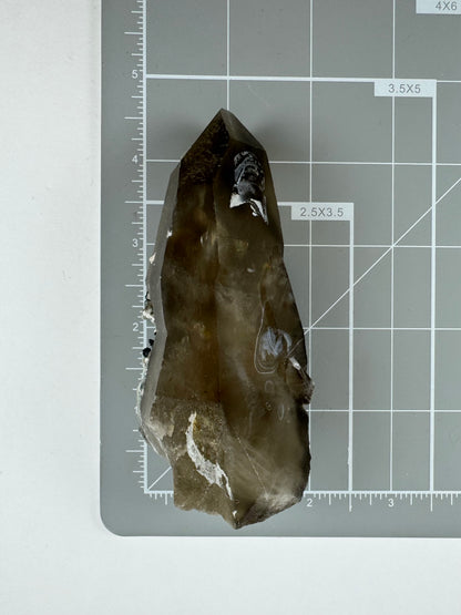 Scale image of the point on a measuring mat, measuring a bit over four and a half inches