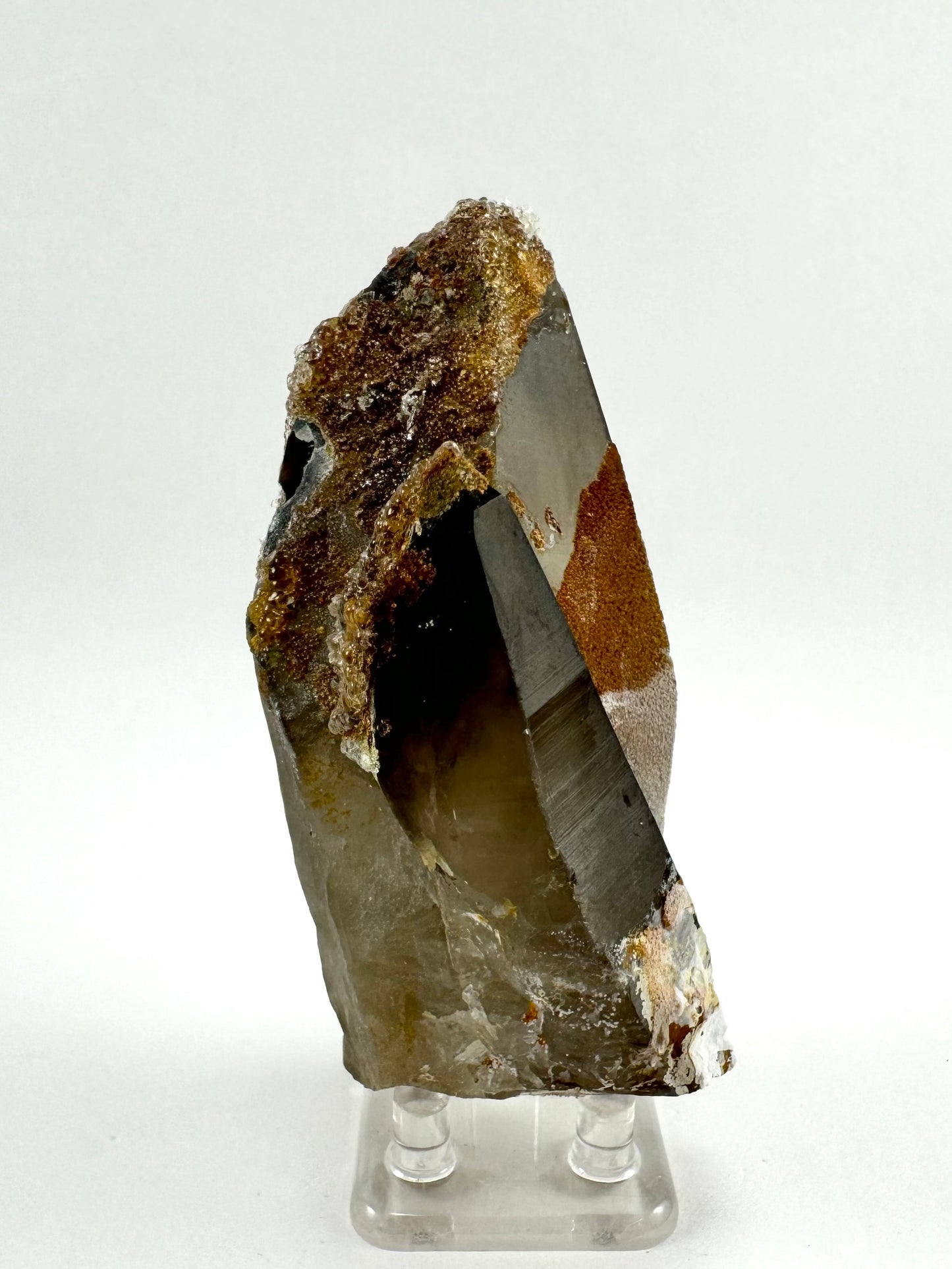 Side-view of the specimen, showing the smaller crystal is about two-thirds the length of the larger crystal, with deep color near the tip. The Larger quartz is shaped like a spear tip.