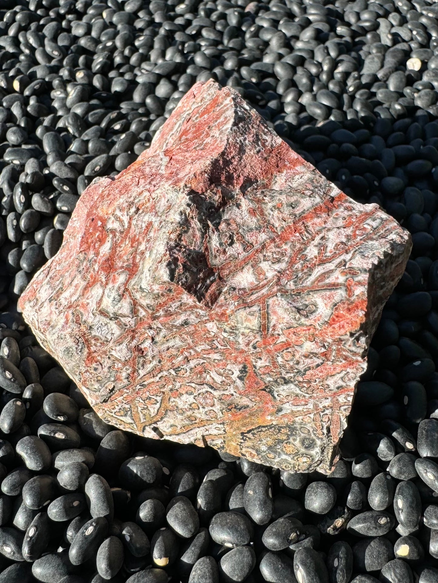 Another side of the piece with vibrant red veining and spots crossing it.