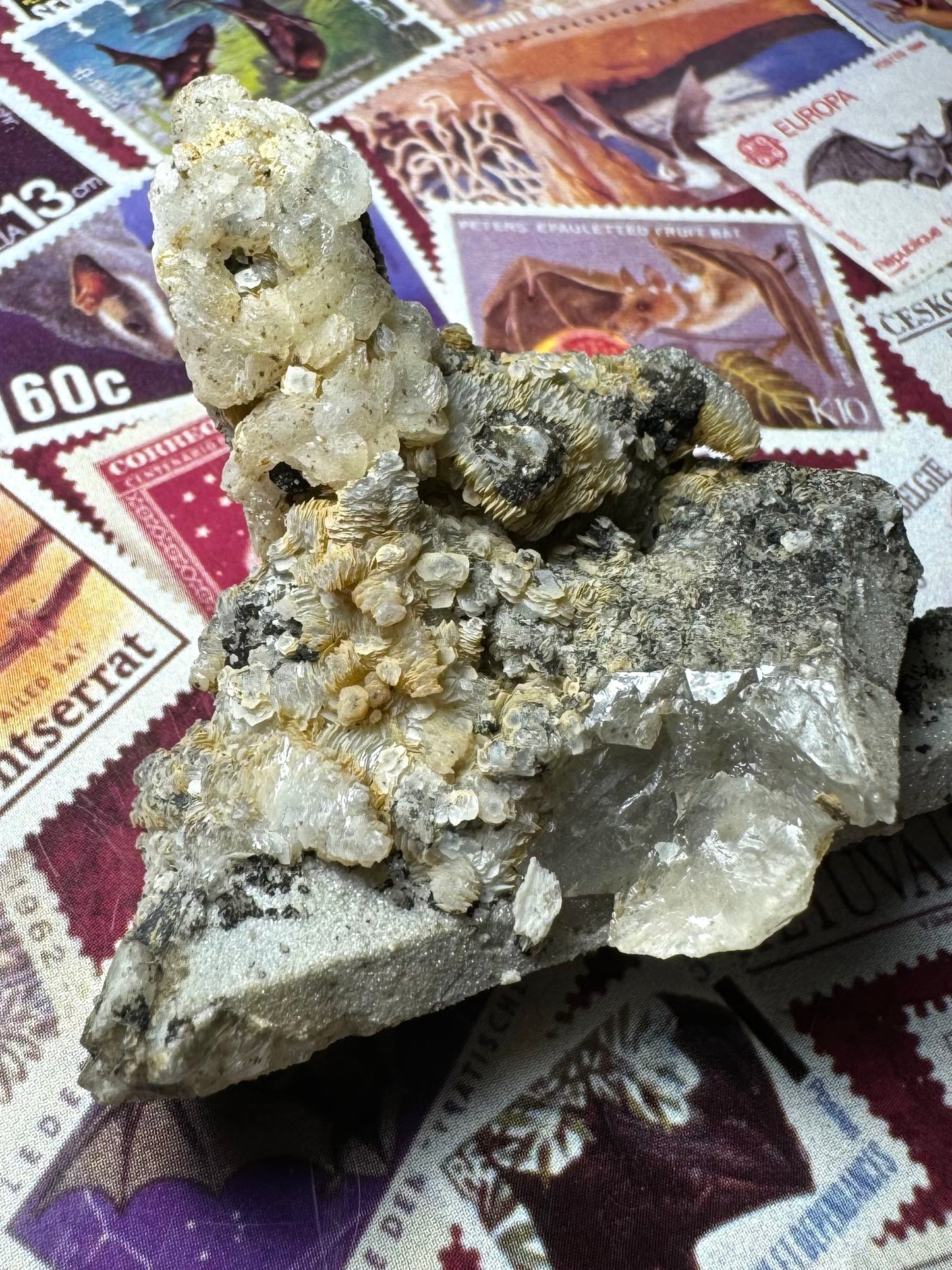 A wider view of the quartz point covered in calcite, also showing the broken end of the partial quartz point on top.