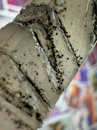 Detail of the dark spheres in the surface, with the lines deeply embedded into the surface in this part and densely filled with the spherical minerals.