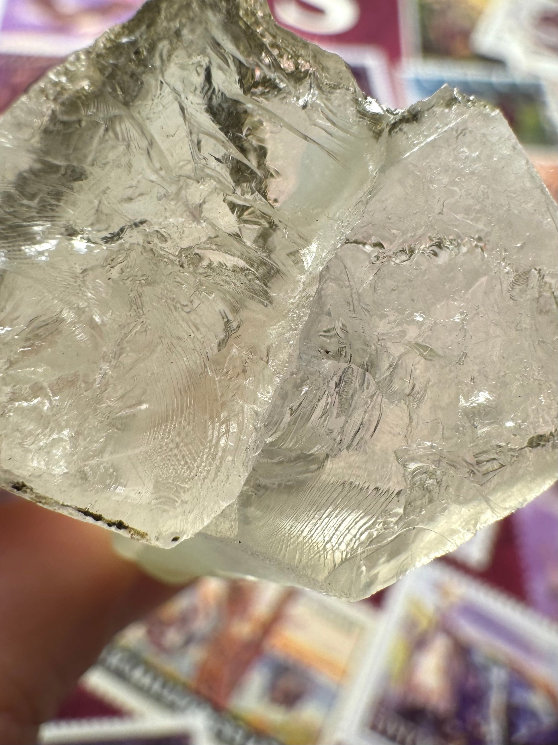 Detail of the broken end of the points, two intergrown hexagons. The interior of the points is glassy and colorless and there is a frosty crust on the outside