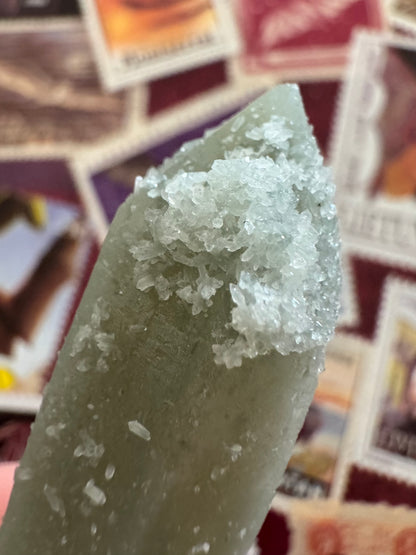 Detail of a cluster of white crystals on the tip of the point, small double-terminated quartz crystals like rice grains.