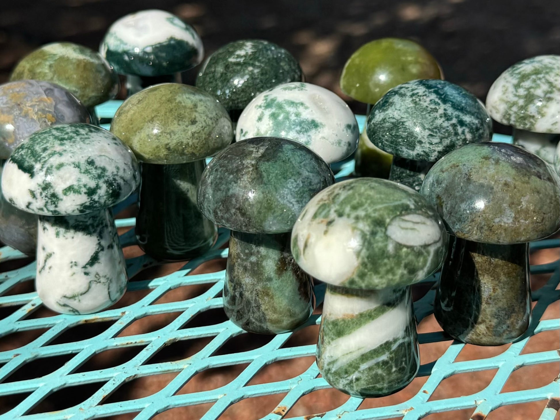 Group of agate carved mushrooms spread out on a table