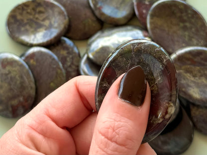 Worry stone in use, held with thumb and fingers