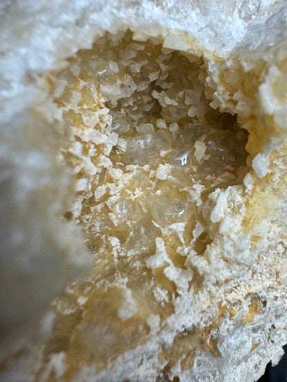 Close detail of the pocket on the back, howing the rhombohedral shape of the small white calcite crystals.