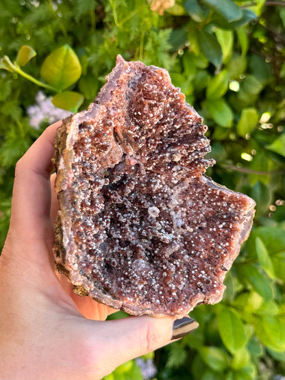 Birds-eye view into the geode, looking down the spires. They are spotted with the white spheres and one has a tutu of mineral around it.