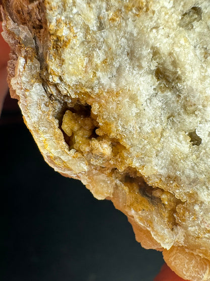 Detail of a cluster of crystals inside a hollow of the crust on the specimen.