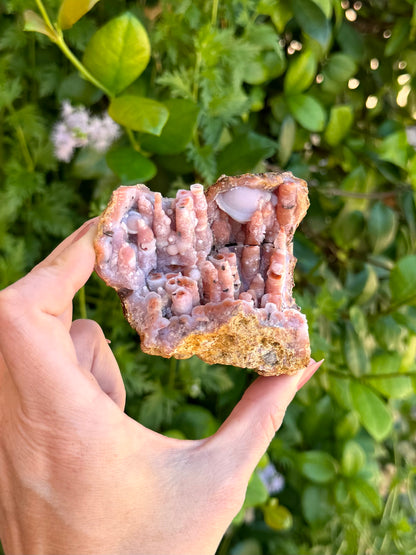 Focusing on the right side of the specimen, there is a large spherical opaque white quartz form near the top of the piece.