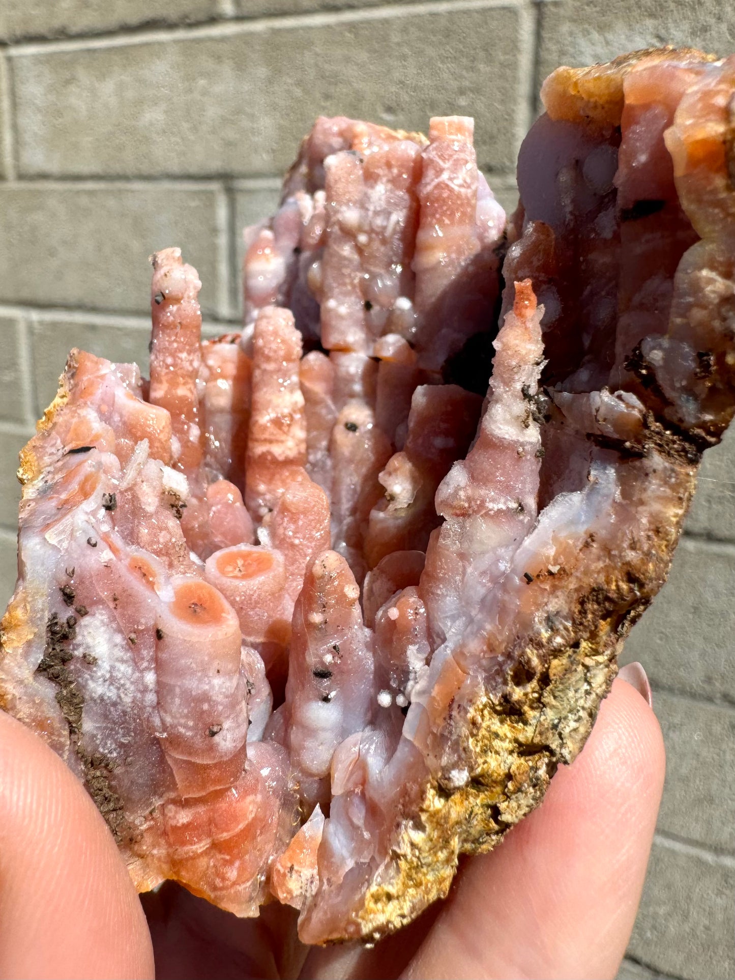 A side-view of the piece showing swirling white agate patterns on the surface of the spires.