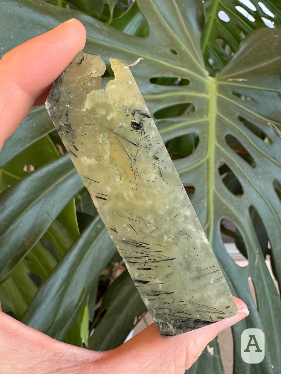 Option A, the backside of the tower, with mottled translucent green prehnite and dark epidote needles concentrated on the left side.