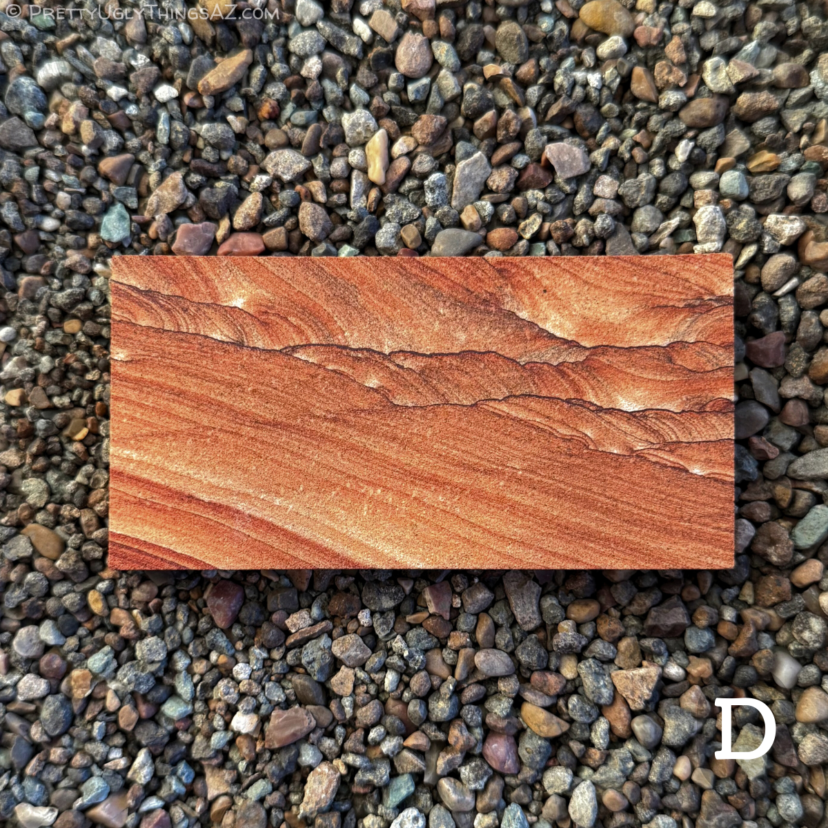 Option D, a long rectangular slab with vibrant red-orange color, divided diagonally into two patterns. The bottom left has broad parallel layering across it, while the upper right side has complex layers of scallop patterning with swirling brown and red tones, and edged with thin dark iron bands.
