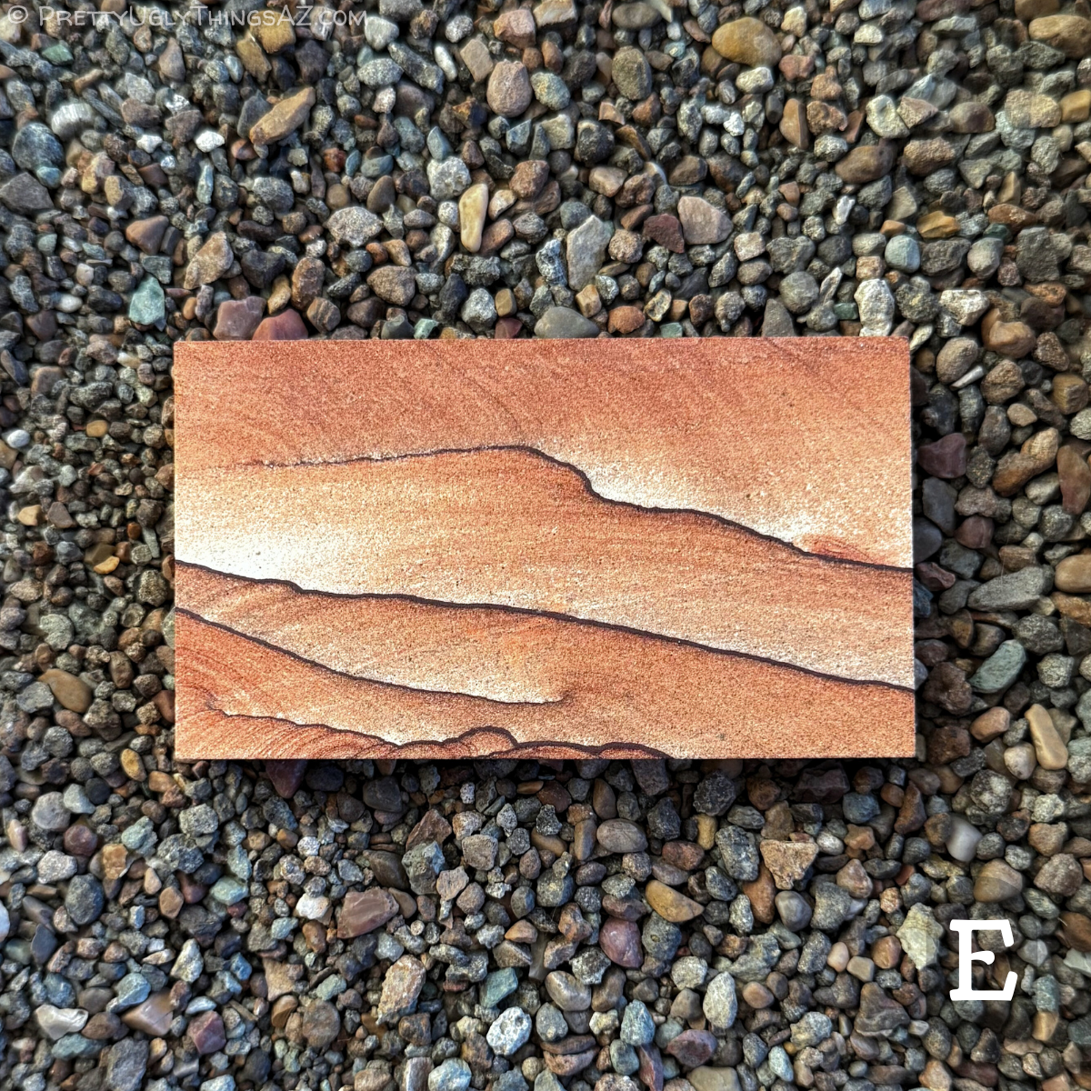 Option E, a slightly long rectangle with lighter orange-red coloration that fades to near-white in a gradient between each thin dark iron band crossing the piece horizontally. The sandstone has faint curved layering.